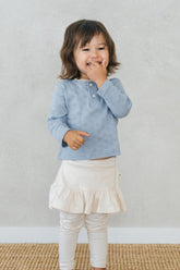 Smiling toddler wearing Avauma Lovely Breeze Henley Shirt in Haze Sky – Comfortable babywear for all-day play